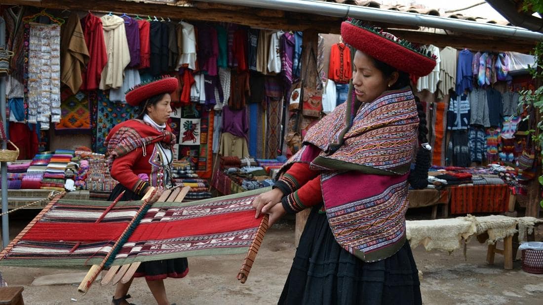 Native Inca women weaving on the streets of Peru'